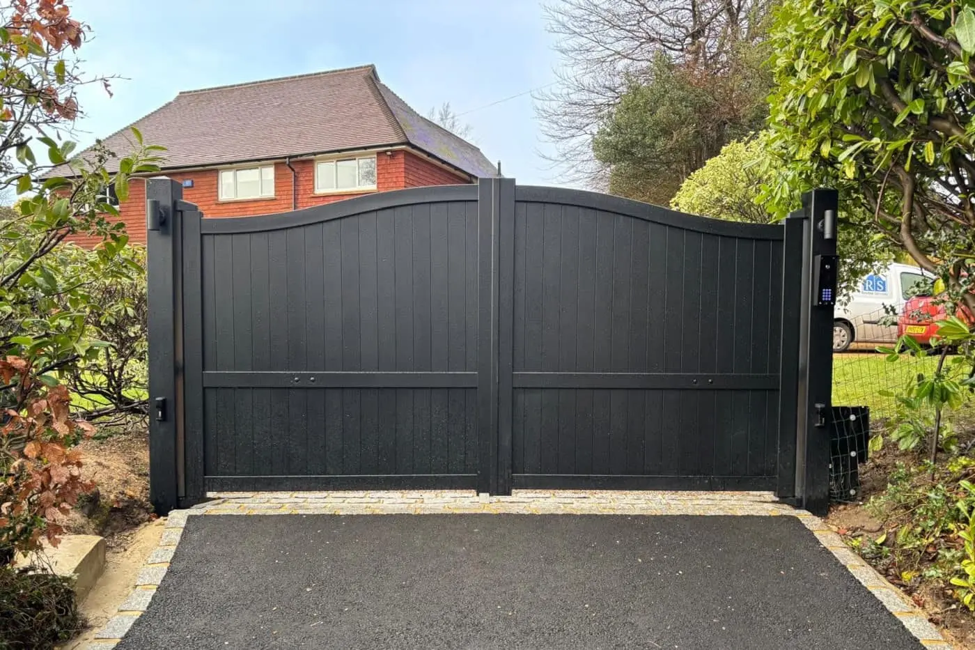 Black automated driveway gates with motor automation installed by Roger Technology approved installers in East Sussex
