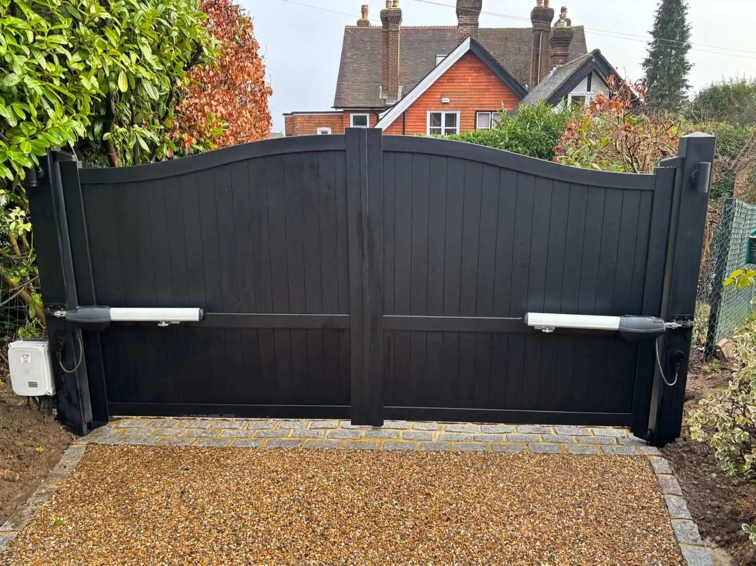 Automated black gates with Roger Technology gate automation motors retrofitted to existing gates by Gate Safe installers in Sussex