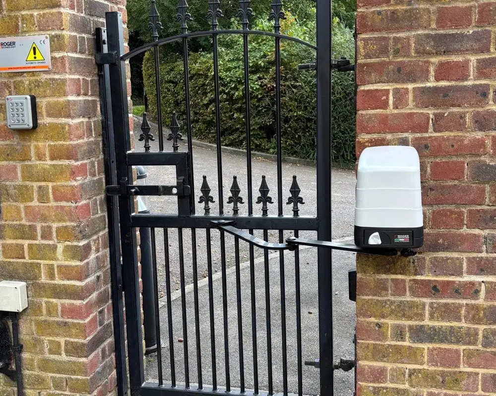 Roger Technology gate automation motor and control system installation showing underground motor setup for swing gates