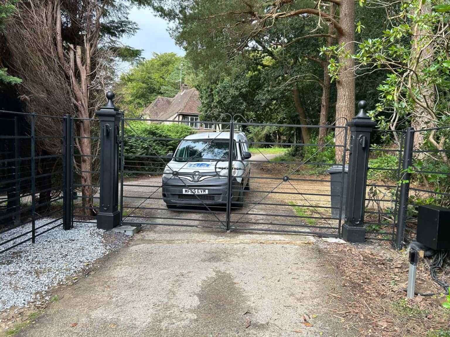 Residential automated metal gate installation for home driveway with Roger Technology motors in Sussex